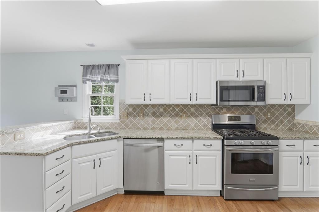23 Crestview Terrace Dallas, GA 30157 - Photo 11 of 36 a kitchen with granite countertop white cabinets and appliances