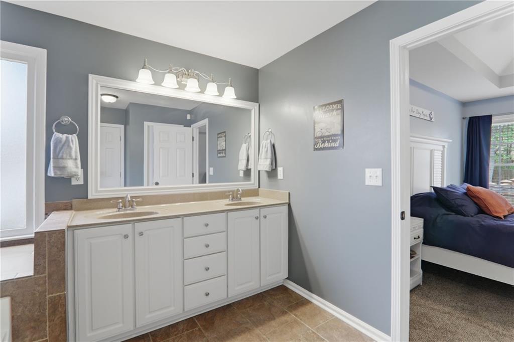 23 Crestview Terrace Dallas, GA 30157 - Photo 21 of 36 a en suite bathroom with a granite countertop sink and a mirror