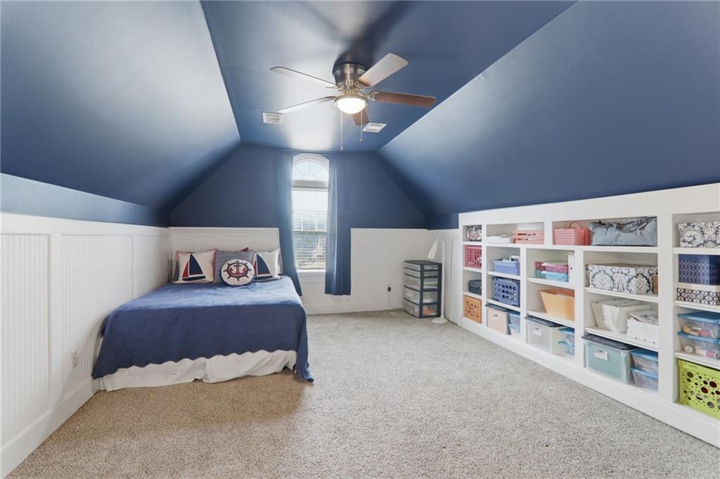23 Crestview Terrace Dallas, GA 30157 - Photo 25 of 36 a spacious bedroom with a bed and a book shelf