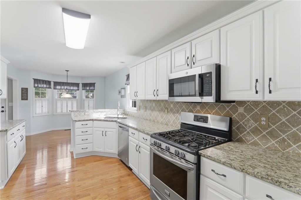 23 Crestview Terrace Dallas, GA 30157 - Photo 9 of 36 a kitchen with stainless steel appliances white cabinets and a stove top oven