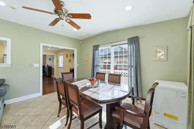 a view of a dining room with furniture and a potted plant