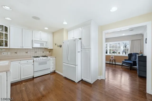 a kitchen with refrigerator and cabinets