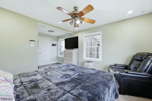 a bedroom with a large bed and a window