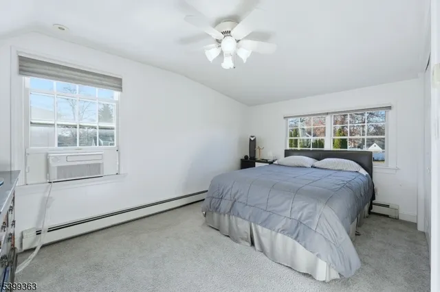 a bedroom with a bed and a large window with outer view