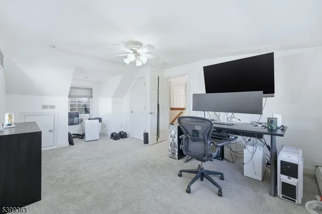 a view of a livingroom with workspace and a couch