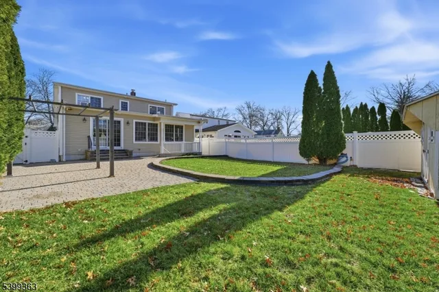a view of a house with a yard and a garden