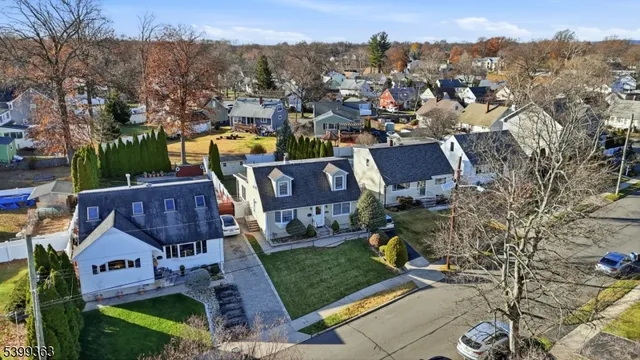 a view of a house with a yard and lake view