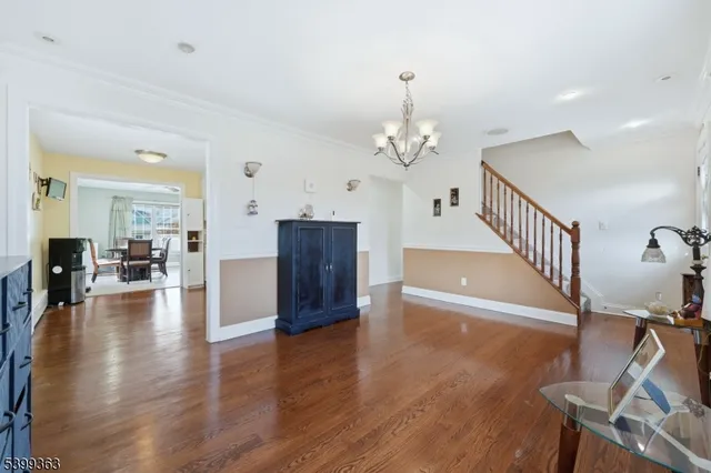a view of a livingroom with dining room and wooden floor
