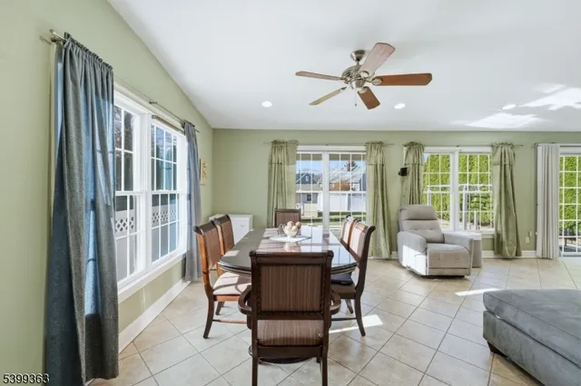 a dining room with furniture window and wooden floor