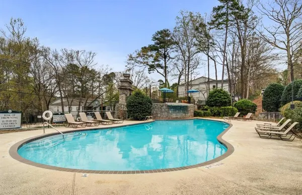 a view of a swimming pool with outdoor seating