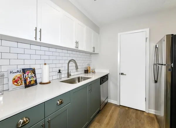 a kitchen with stainless steel appliances a sink and a refrigerator