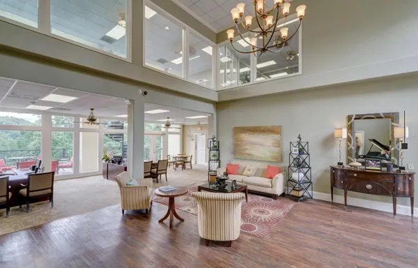 a living room with furniture and a chandelier