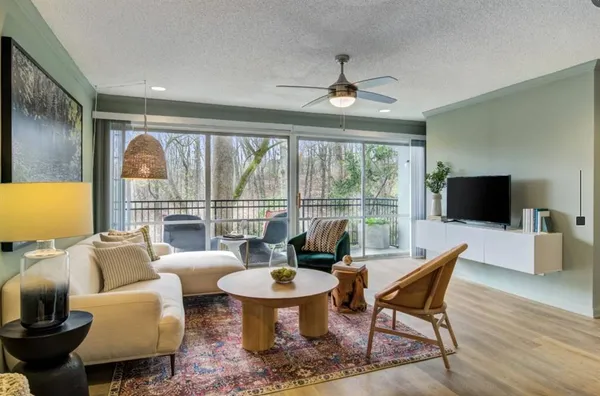 a living room with furniture and a large window