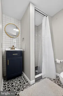 a view of a bathroom with a sink and a mirror