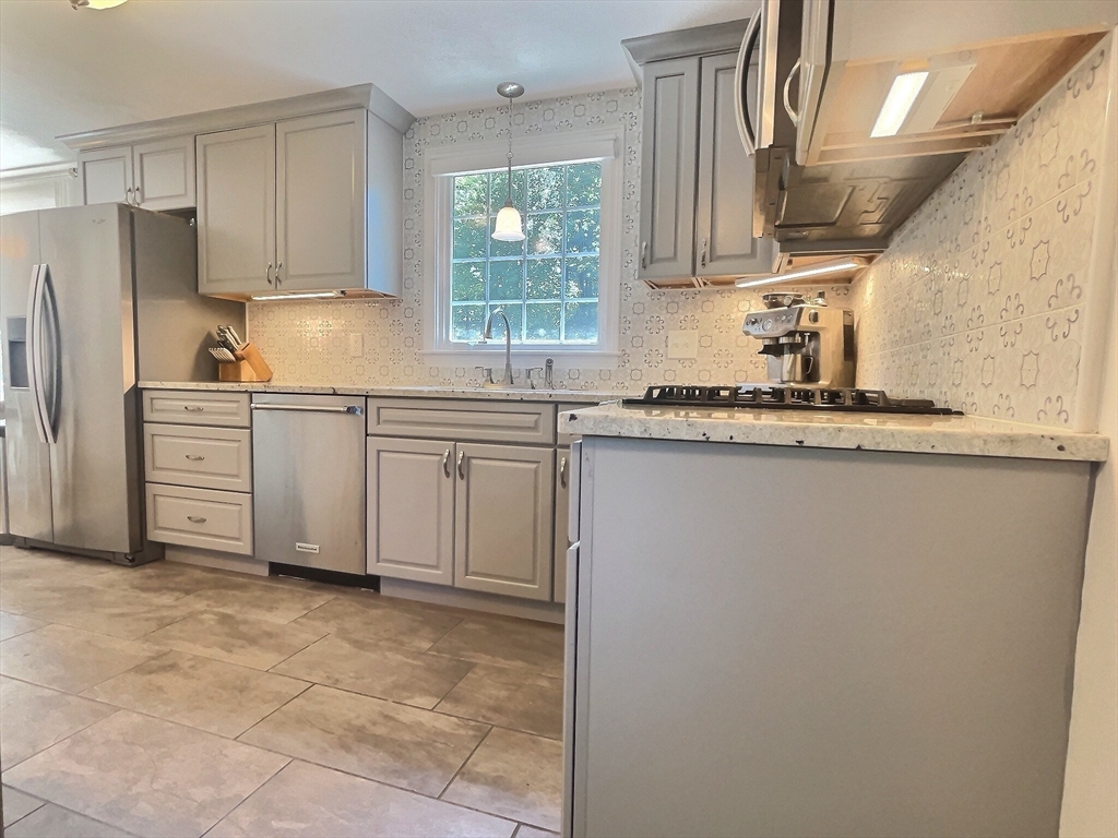30 Edward Road Townsend, MA 01469 - Photo 4 of 42 a kitchen with stainless steel appliances granite countertop a sink a stove a refrigerator and cabinets