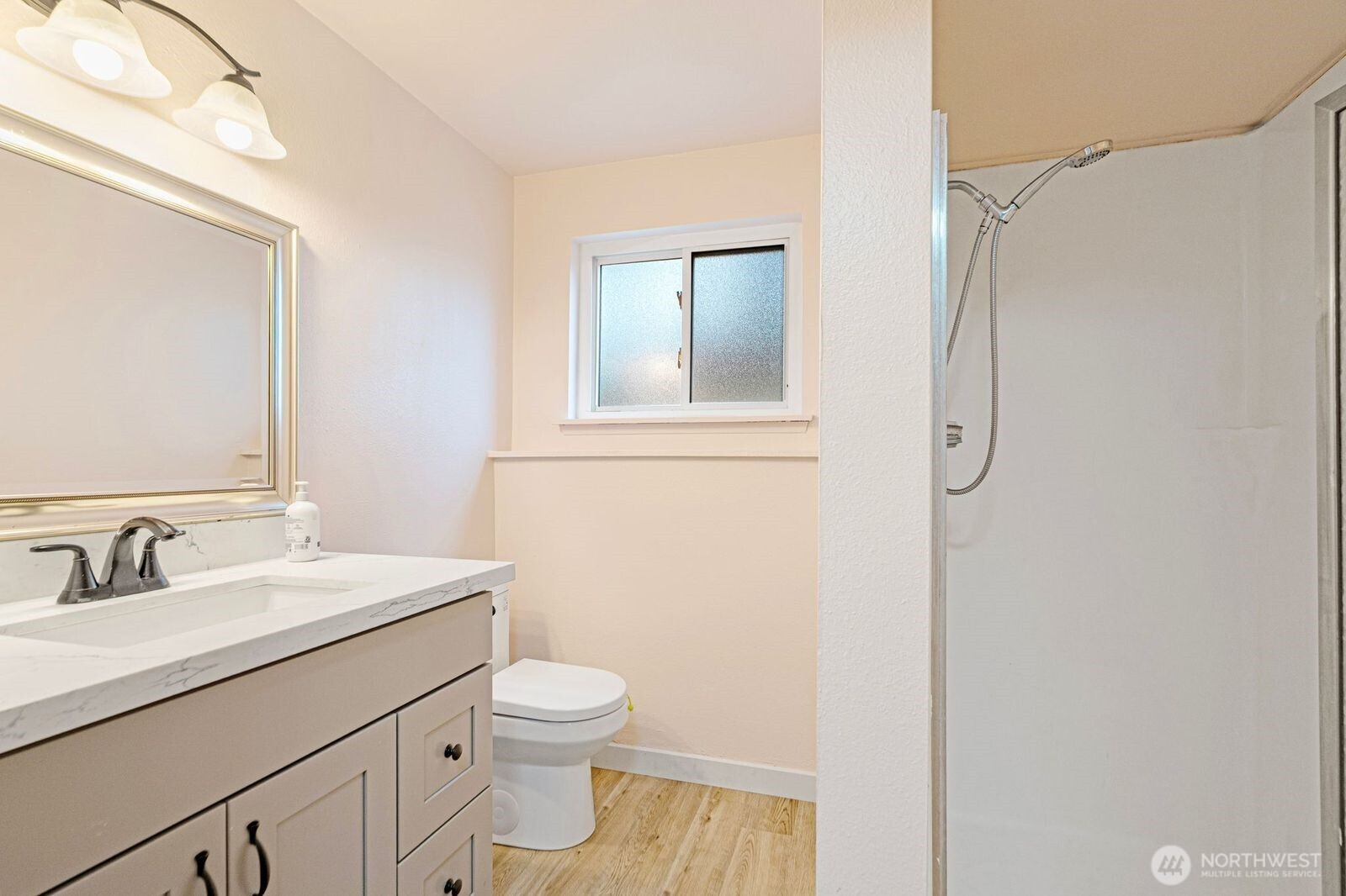 1102 156th Street East Tacoma, WA 98445 - Photo 11 of 20 a bathroom with a sink a toilet and shower