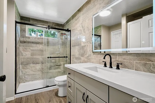 a bathroom with a sink toilet and shower