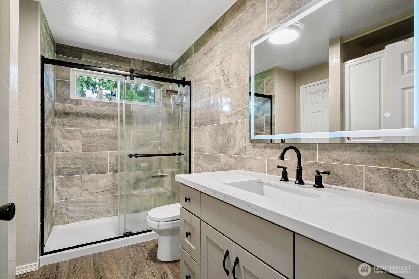 1102 156th Street East Tacoma, WA 98445 - Photo 12 of 20 a bathroom with a sink toilet and shower