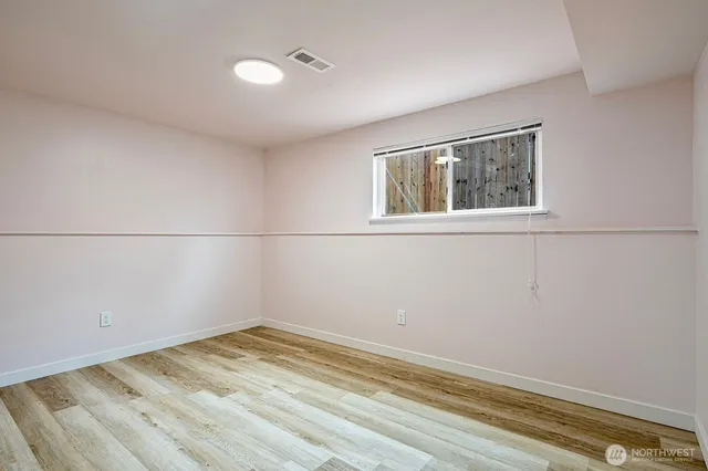 a view of a room with wooden floor