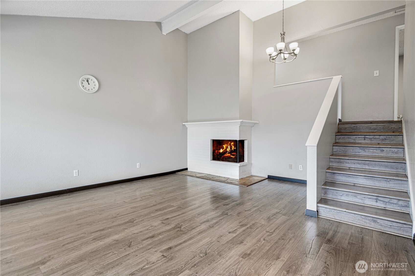 1102 156th Street East Tacoma, WA 98445 - Photo 4 of 20 a view of an empty room with wooden floor and a window