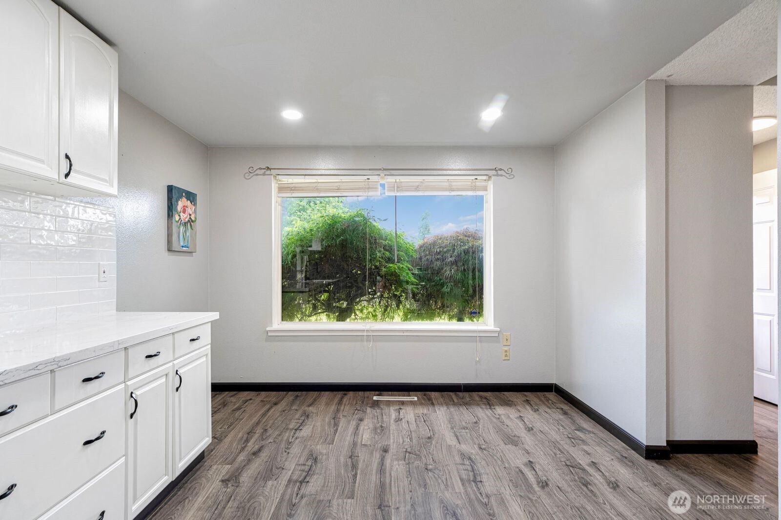 1102 156th Street East Tacoma, WA 98445 - Photo 7 of 20 a view of an empty room with a window and wooden floor