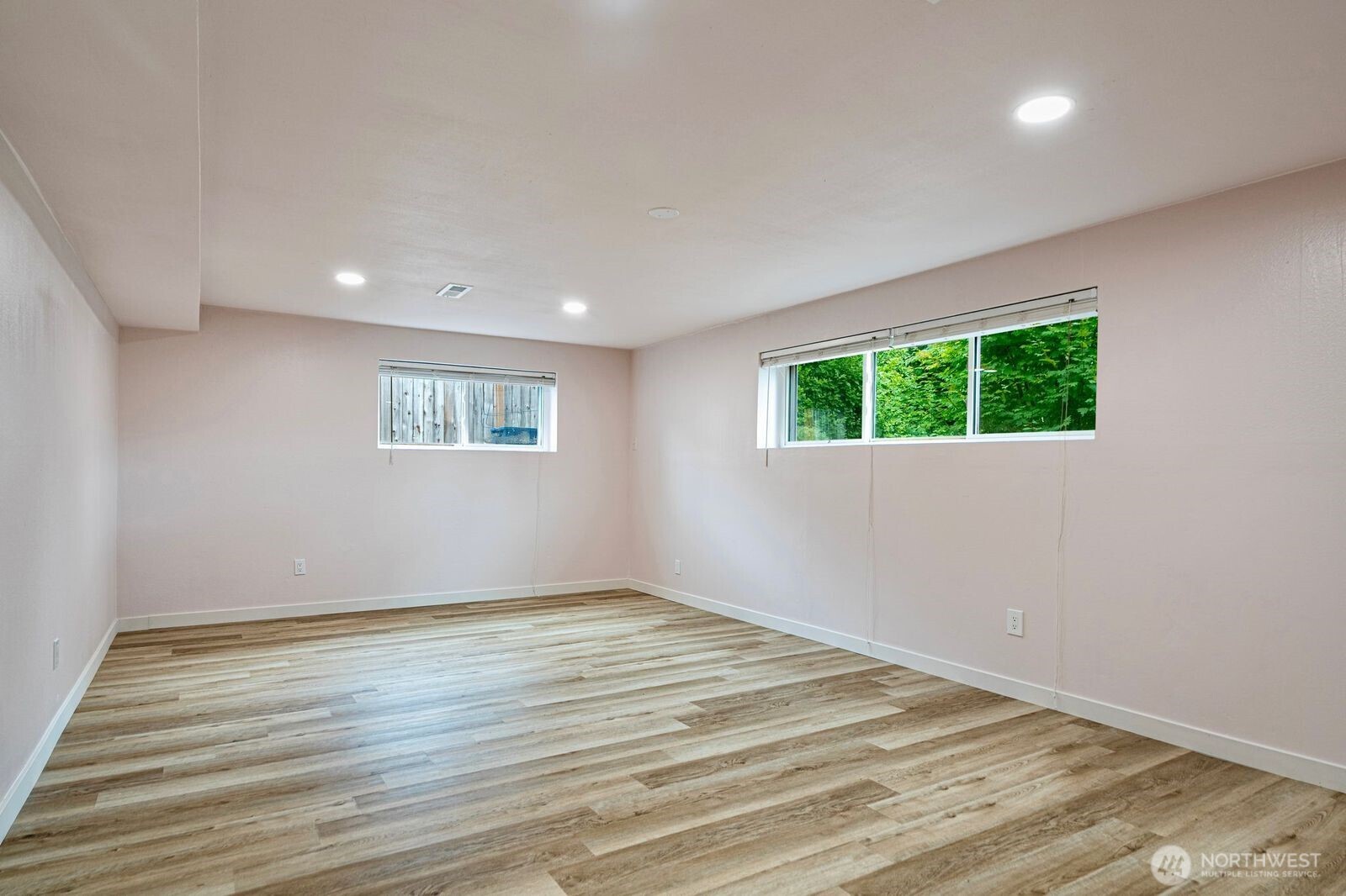 1102 156th Street East Tacoma, WA 98445 - Photo 9 of 20 a view of an empty room with wooden floor and a window