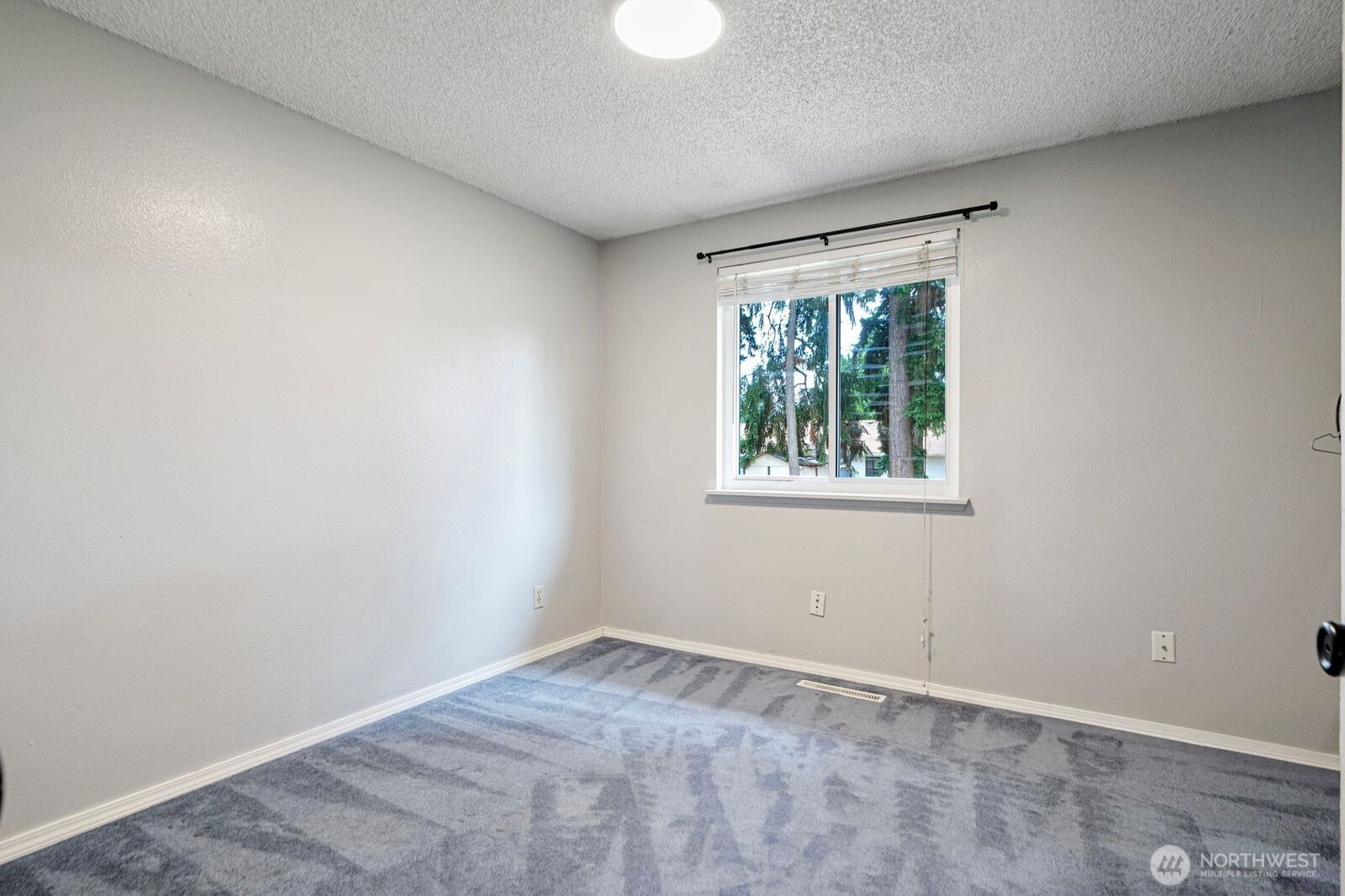 1102 156th Street East Tacoma, WA 98445 - Photo 10 of 20 a view of an empty room with a window