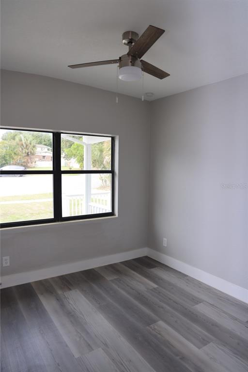 179 Alder Court Altamonte Springs, FL 32714 - Photo 12 of 77 an empty room with wooden floor and windows