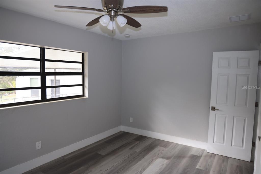 179 Alder Court Altamonte Springs, FL 32714 - Photo 16 of 77 a view of an empty room with a window and wooden floor