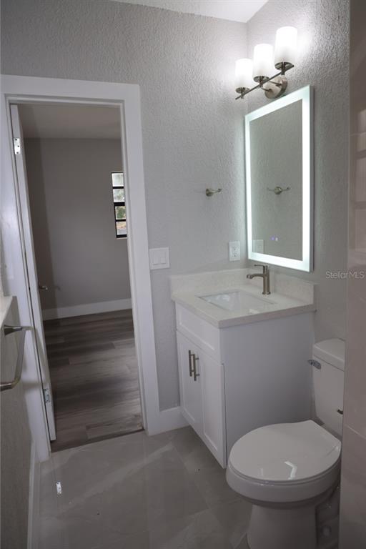 179 Alder Court Altamonte Springs, FL 32714 - Photo 21 of 77 a bathroom with a toilet sink and mirror