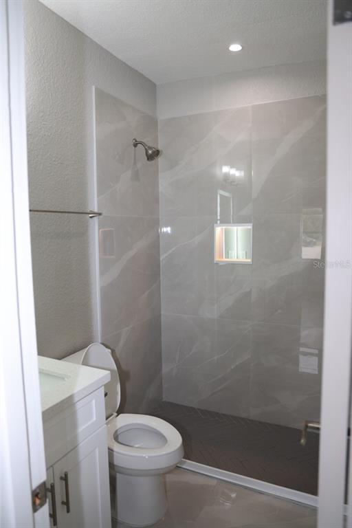 179 Alder Court Altamonte Springs, FL 32714 - Photo 22 of 77 a bathroom with a shower and a toilet