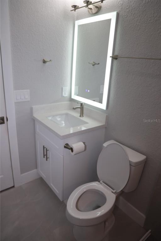 179 Alder Court Altamonte Springs, FL 32714 - Photo 23 of 77 a bathroom with a toilet a sink and mirror