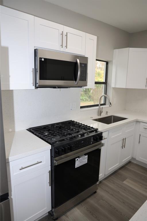 179 Alder Court Altamonte Springs, FL 32714 - Photo 28 of 77 a kitchen with stainless steel appliances a stove microwave and sink
