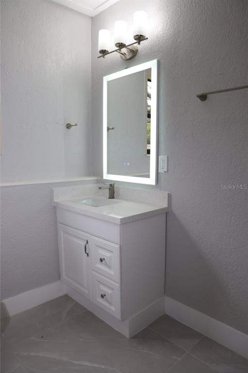 179 Alder Court Altamonte Springs, FL 32714 - Photo 43 of 77 a bathroom with a sink vanity and a mirror