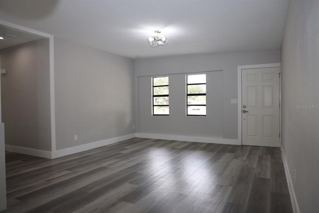 179 Alder Court Altamonte Springs, FL 32714 - Photo 5 of 77 an empty room with wooden floor and windows
