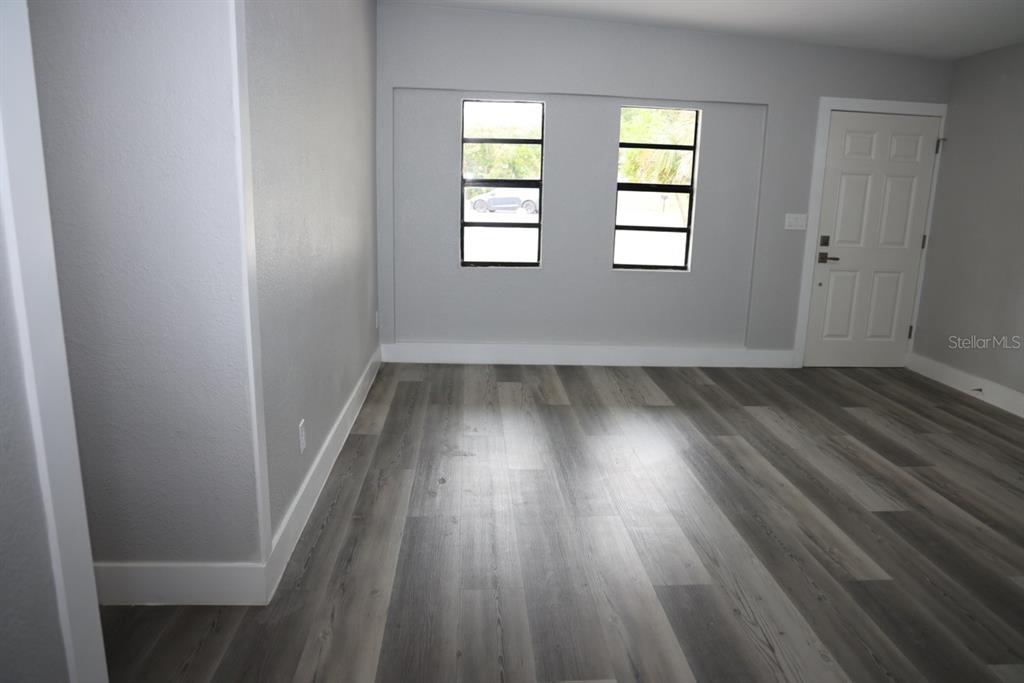 179 Alder Court Altamonte Springs, FL 32714 - Photo 7 of 77 an empty room with wooden floor and windows