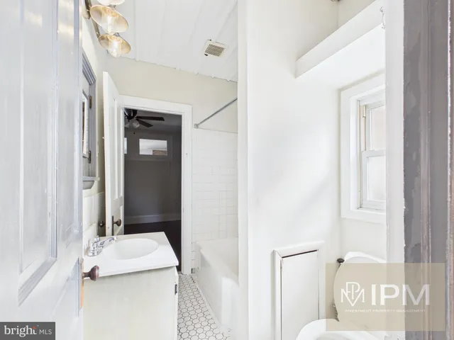 a bathroom with a sink a mirror and a bathtub
