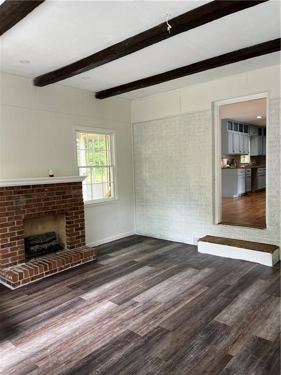 1432 Spring Valley Lane Lilburn, GA 30047 - Photo 3 of 11 a view of an empty room with wooden floor fireplace and a window