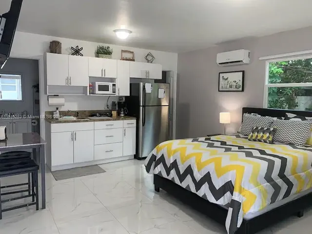 a bed sitting in a bedroom next to a window