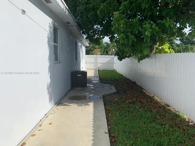 a view of a backyard with pathway