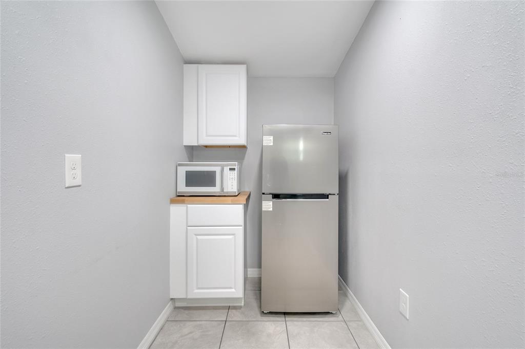 113 Jay Drive Altamonte Springs, FL 32714 - Photo 11 of 14 a view of a kitchen with refrigerator and cabinet