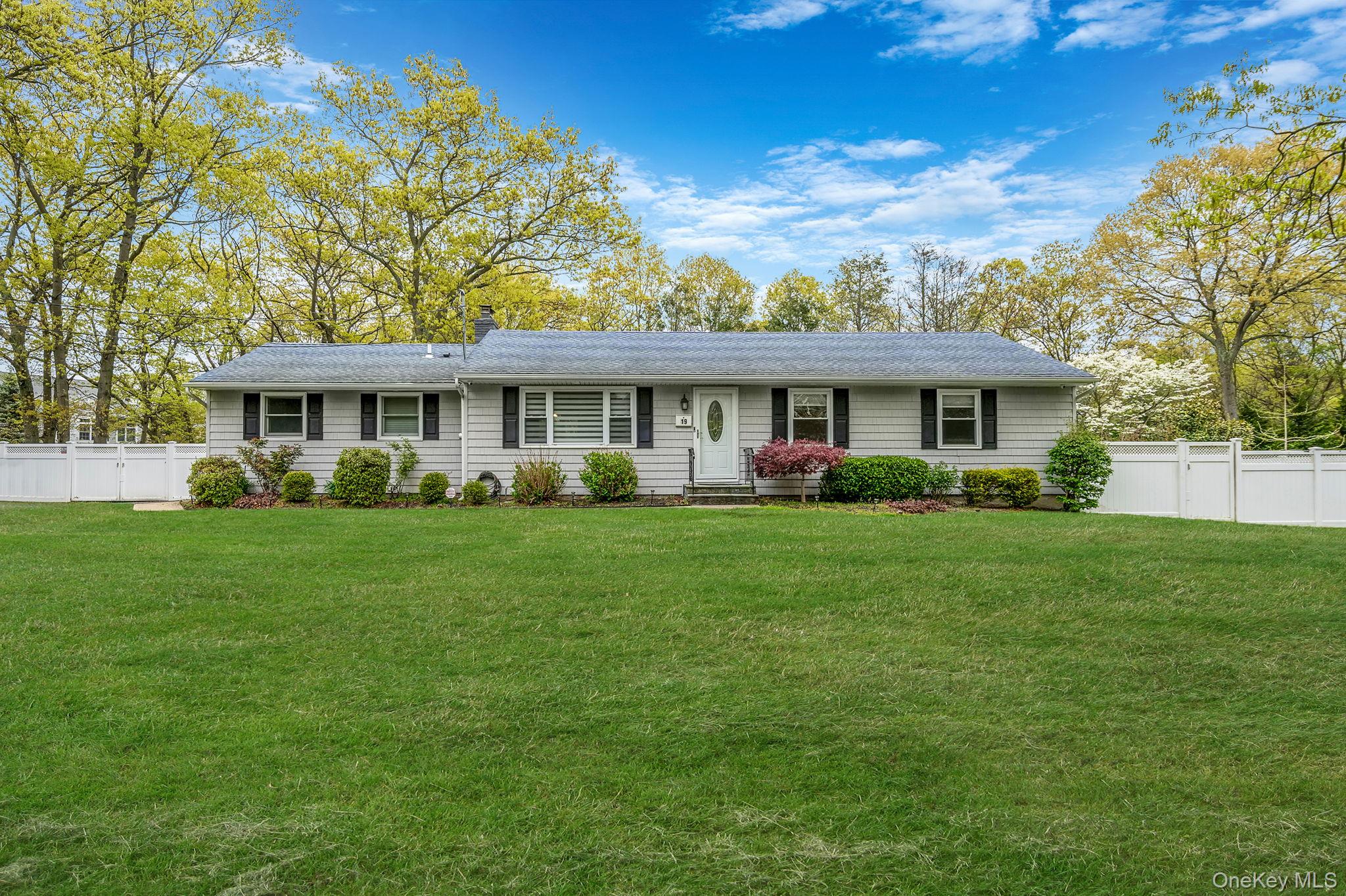 19 Pumpkin Road St. James, NY 11780 - Photo 1 of 35 a front view of a house with a yard