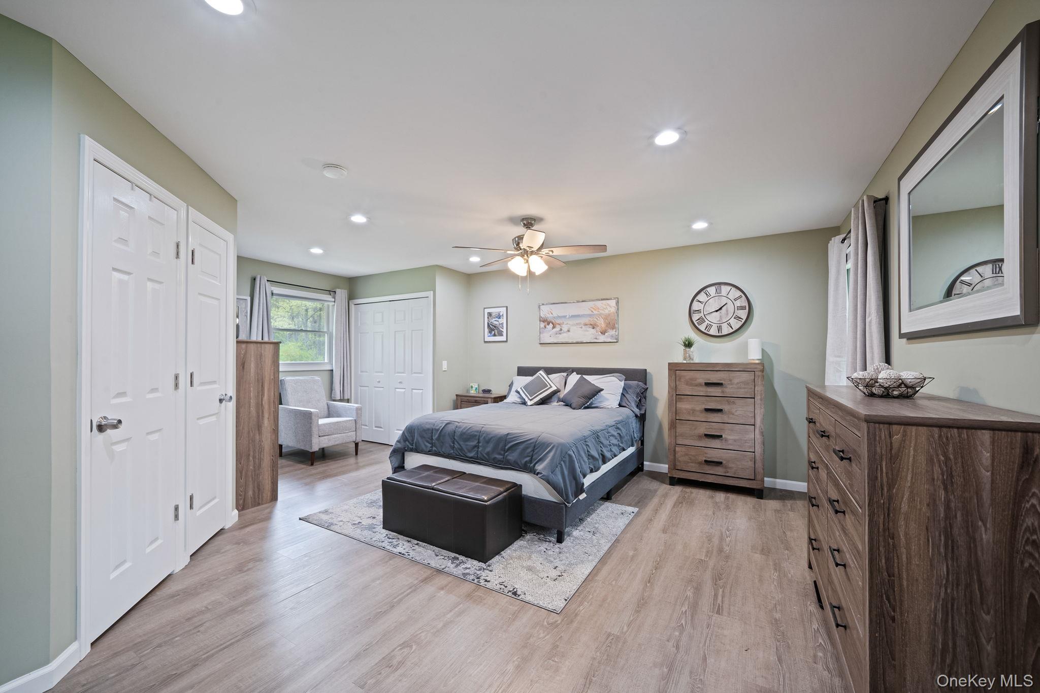 19 Pumpkin Road St. James, NY 11780 - Photo 13 of 35 a spacious bedroom with a bed and a dresser