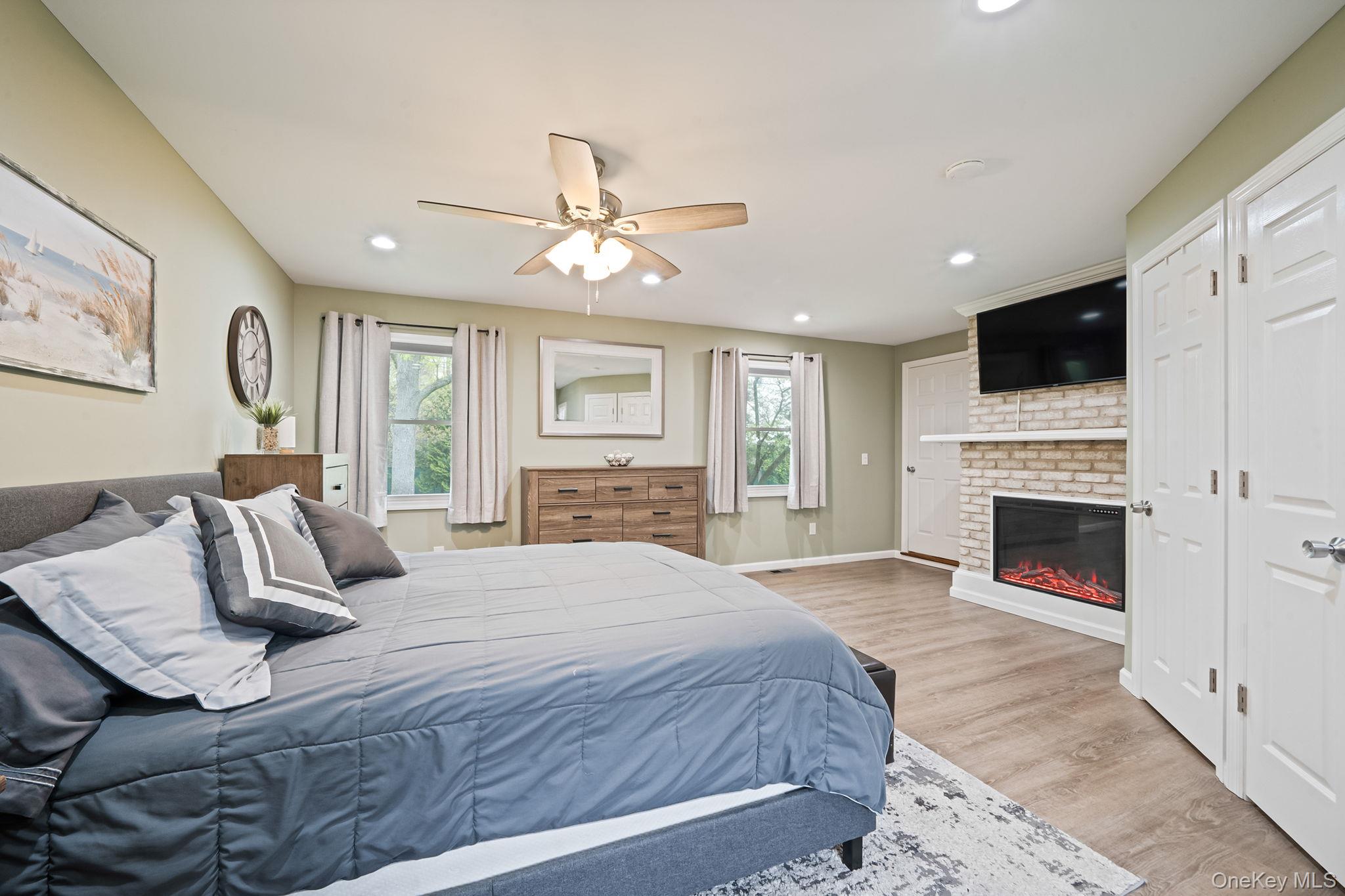 19 Pumpkin Road St. James, NY 11780 - Photo 14 of 35 a bedroom with a large bed and a flat screen tv