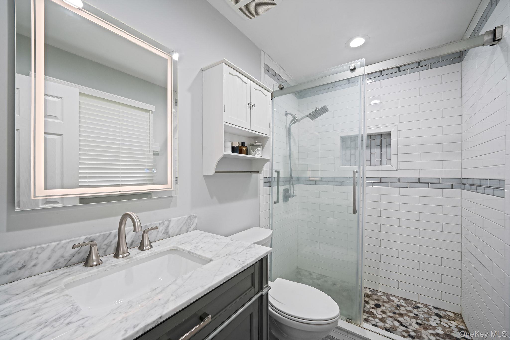 19 Pumpkin Road St. James, NY 11780 - Photo 15 of 35 a bathroom with a granite countertop sink toilet a large mirror and shower