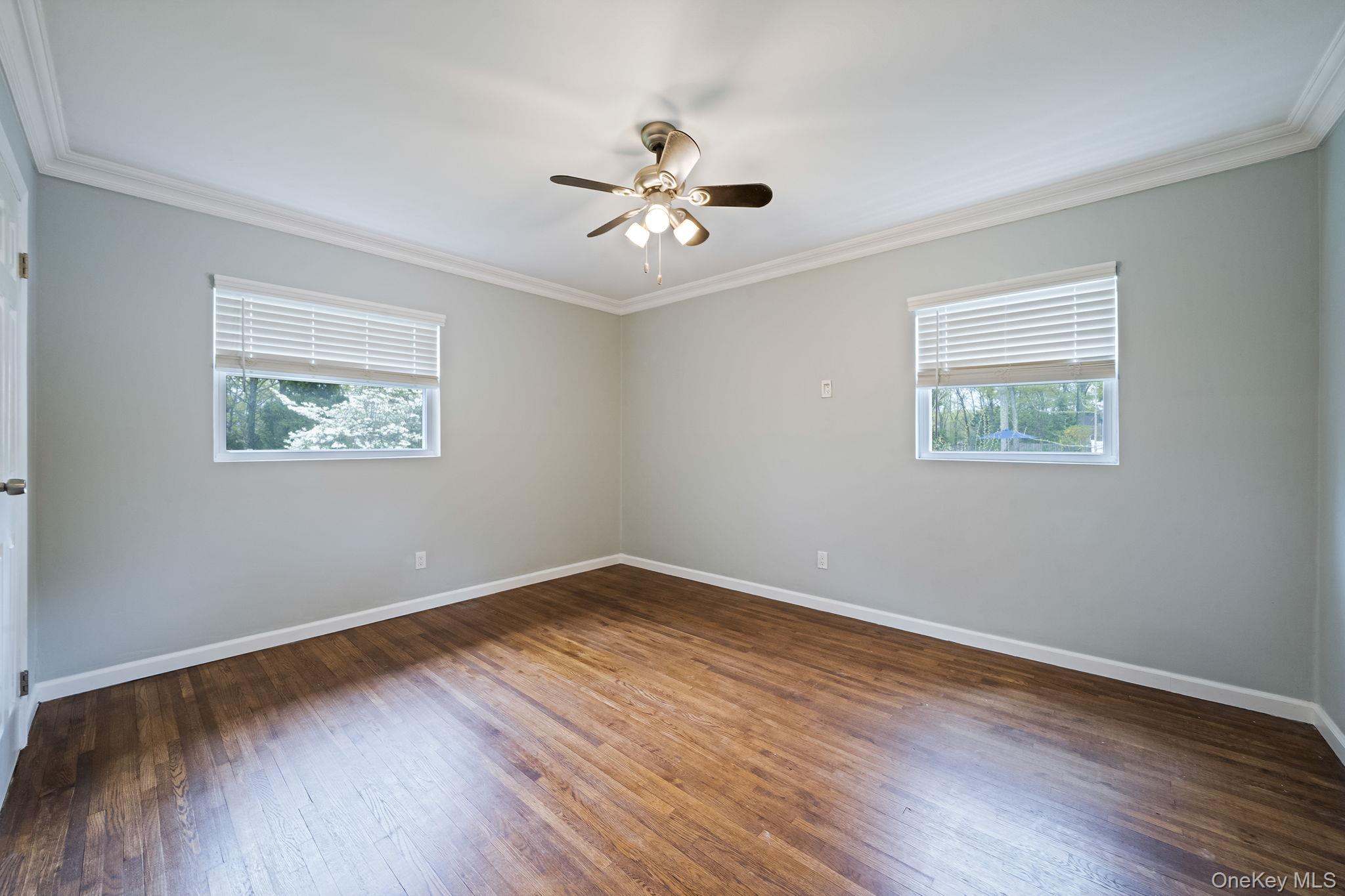 19 Pumpkin Road St. James, NY 11780 - Photo 17 of 35 a view of an empty room with wooden floor and a window