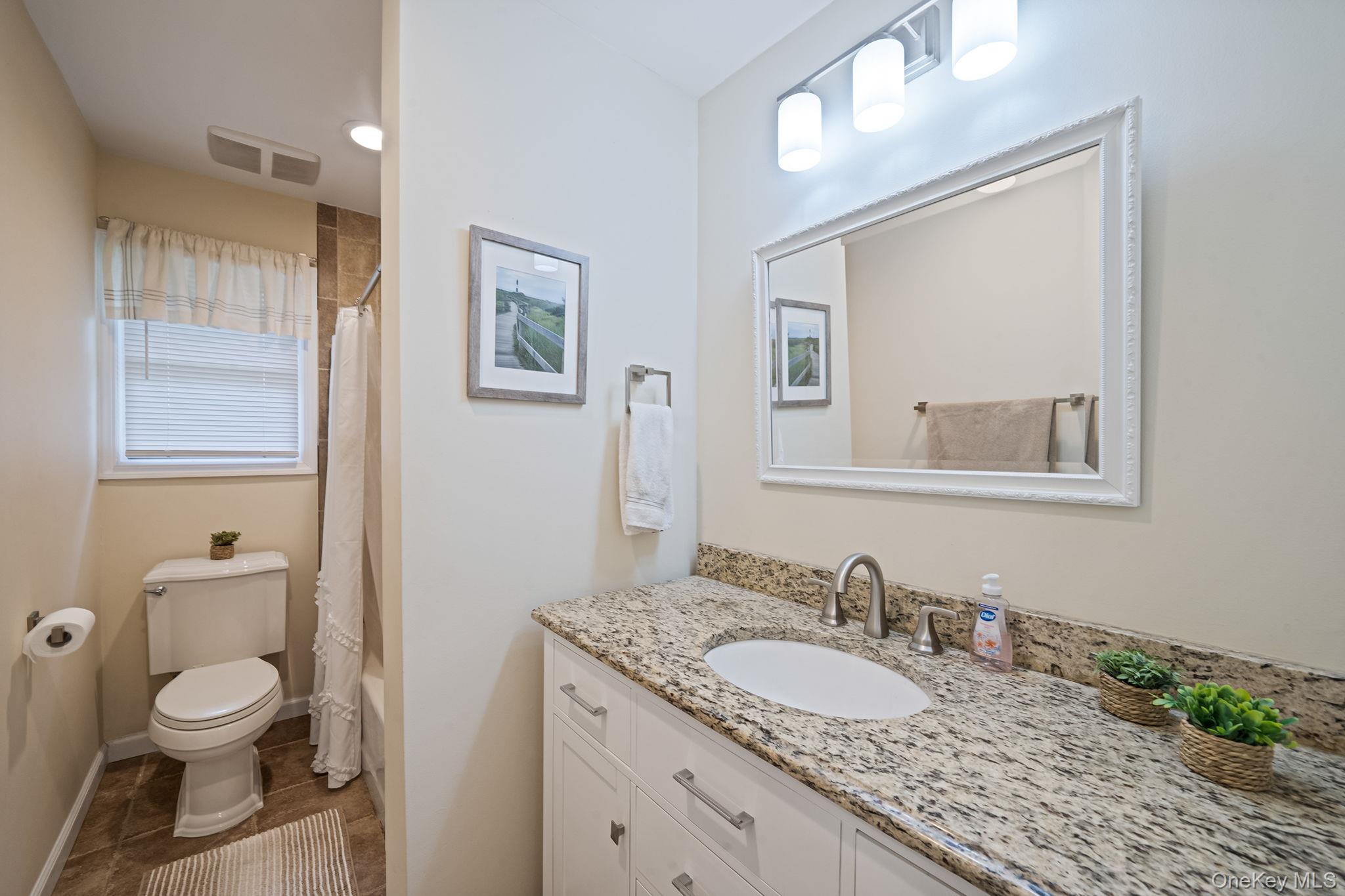 19 Pumpkin Road St. James, NY 11780 - Photo 19 of 35 a bathroom with a granite countertop sink toilet and a mirror