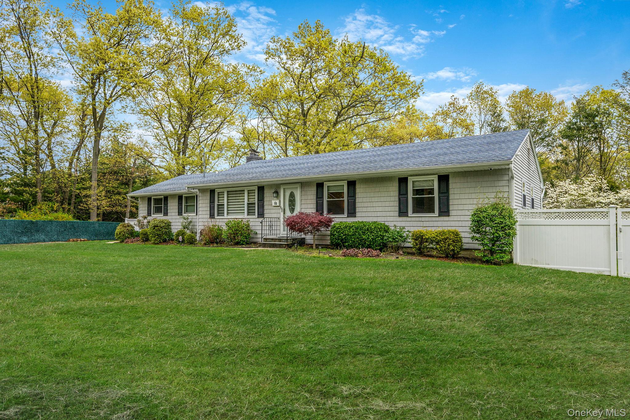 19 Pumpkin Road St. James, NY 11780 - Photo 3 of 35 a front view of a house with a yard