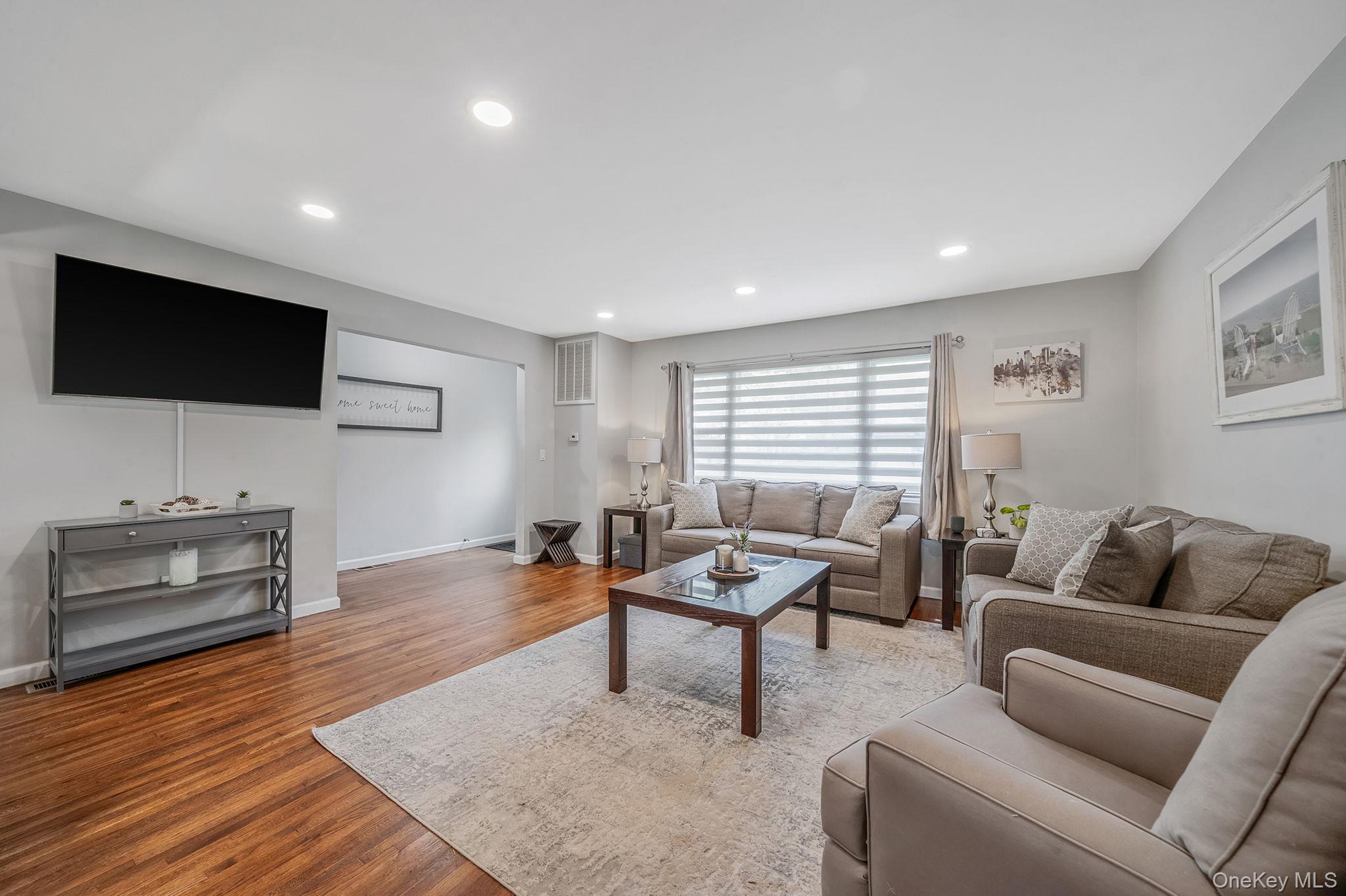 19 Pumpkin Road St. James, NY 11780 - Photo 5 of 35 a living room with furniture and a flat screen tv