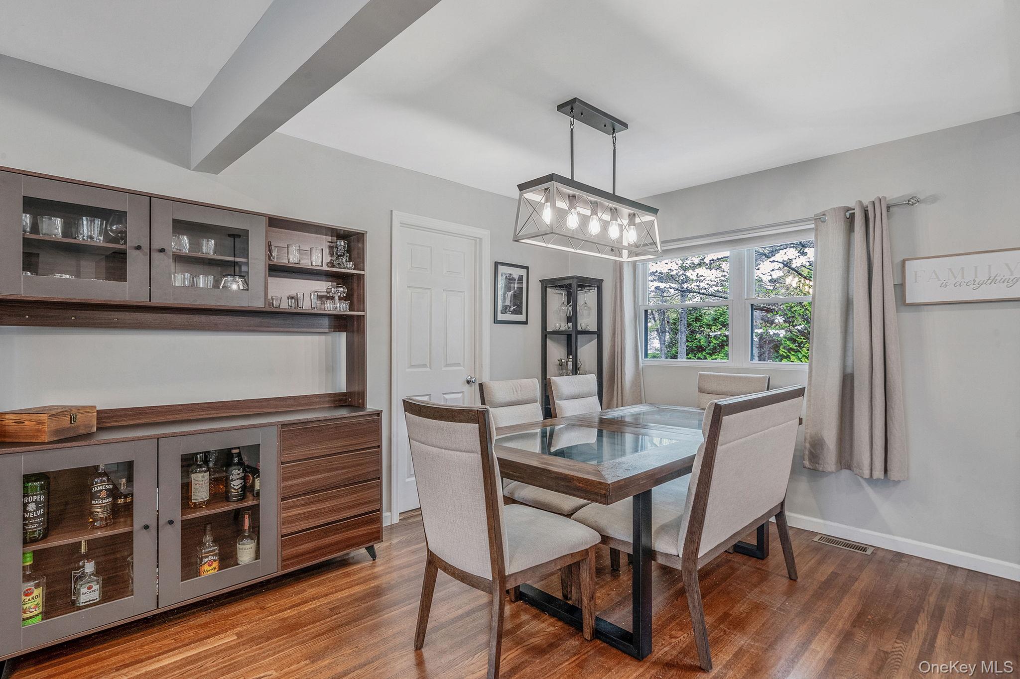 19 Pumpkin Road St. James, NY 11780 - Photo 8 of 35 a view of a dining room with furniture window and wooden floor